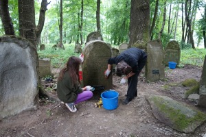 Local residents help clean the tombstones in Lesko